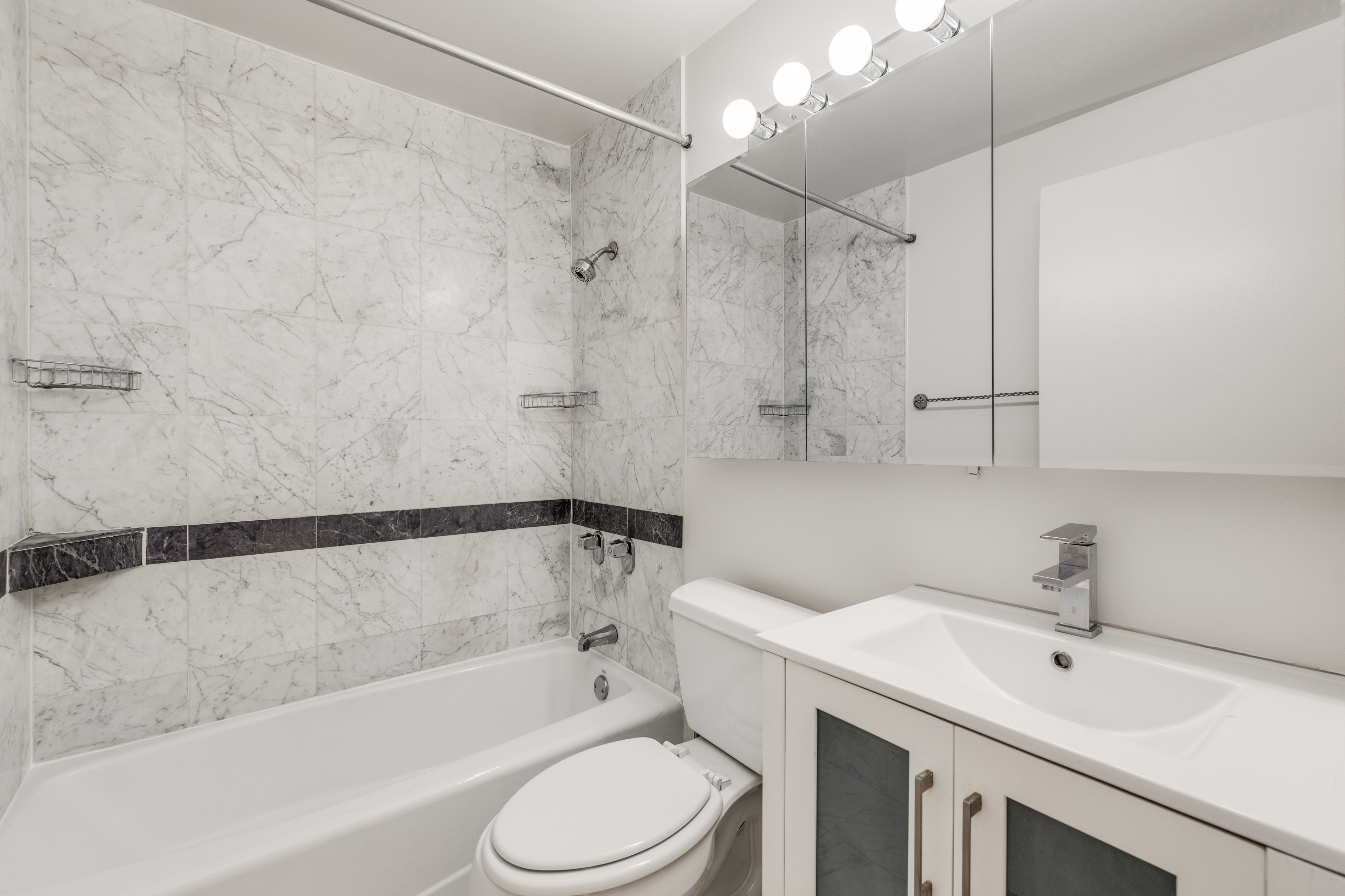 50 Lexington Avenue, Unit 12G Manhattan, NY 10010 - Photo 4 of 8 a bathroom with a sink toilet and shower