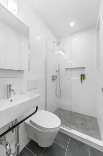 a bathroom with a sink toilet and shower
