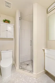 a bathroom with a toilet a sink and shower