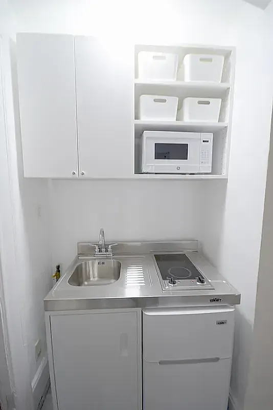 a utility room with a sink and cabinets