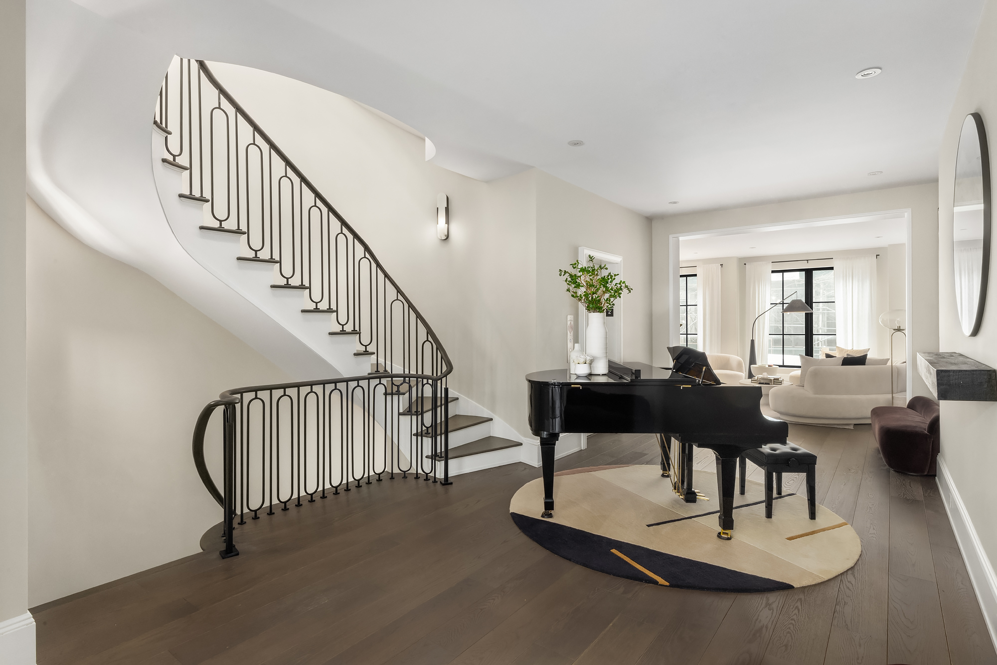 123 East 61st Street Manhattan, NY 10065 - Photo 5 of 31 a living room with couches coffee table and a dining table with wooden floor