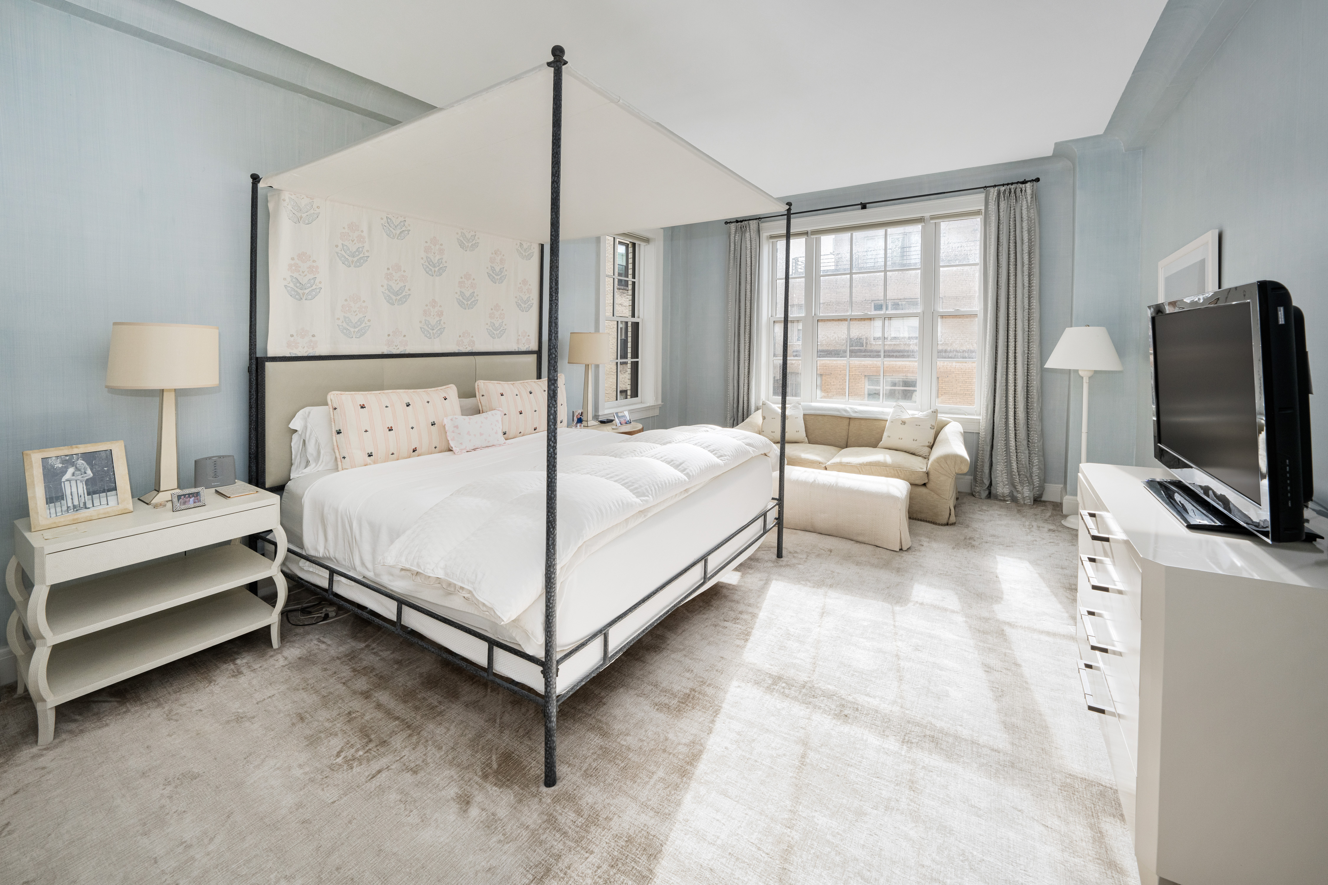 850 Park Avenue, Unit 9C Manhattan, NY 10075 - Photo 9 of 14 a bedroom with a bed flat screen tv and a large window