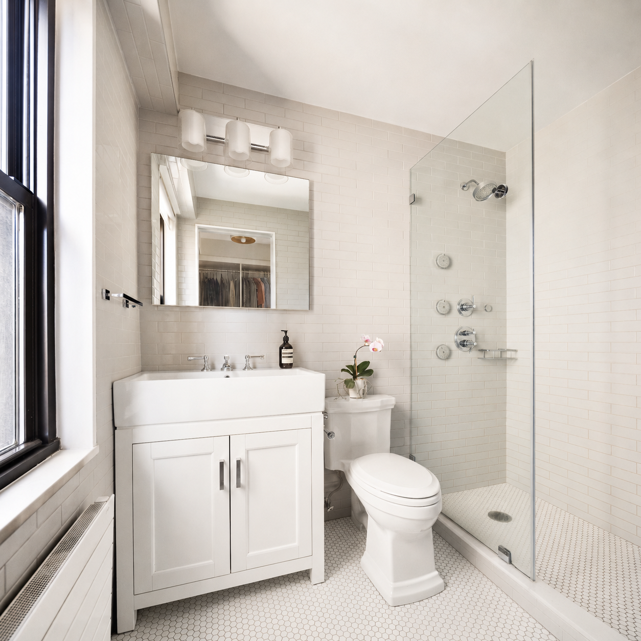 1065 Park Avenue, Unit 10CD Manhattan, NY 10128 - Photo 8 of 10 a bathroom with a toilet a sink and a mirror