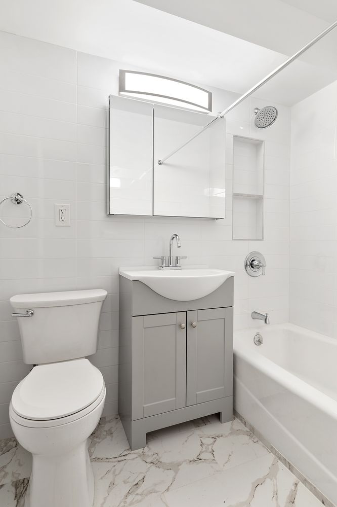 122 Ashland Place, Unit 15B Brooklyn, NY 11201 - Photo 5 of 15 a bathroom with a sink toilet and shower