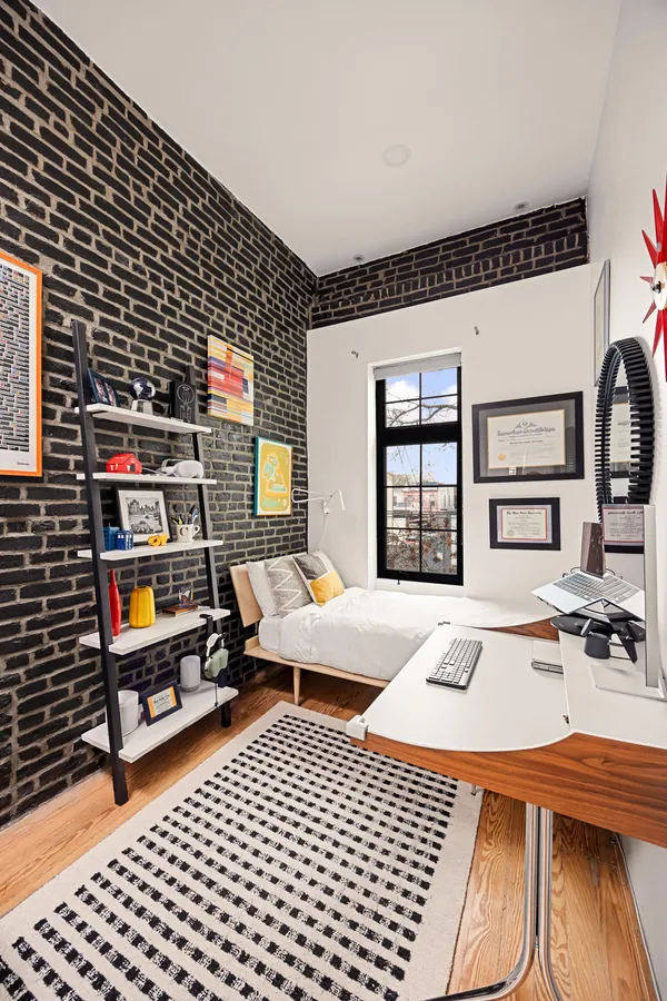 a bedroom with furniture and a book shelf
