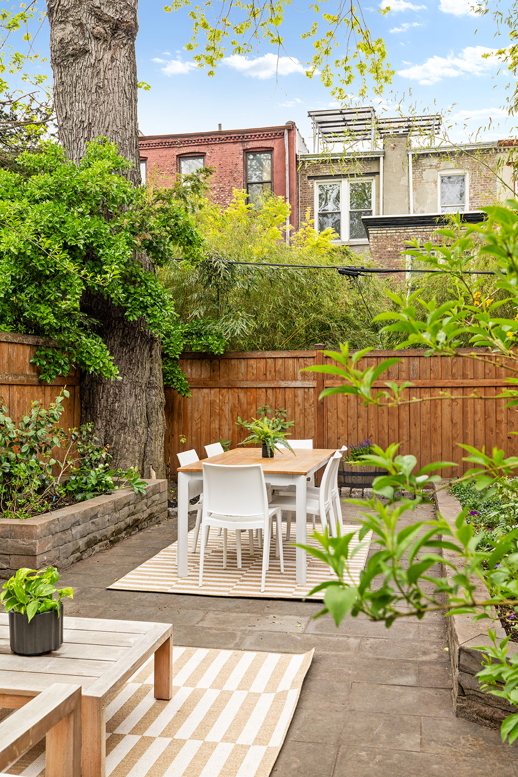 219 Fenimore Street Brooklyn, NY 11225 - Photo 9 of 24 a view of a patio with table and chairs and potted plants