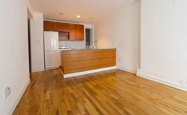 a view of kitchen cabinets and wooden floor