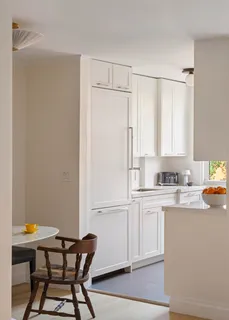 a kitchen with granite countertop white cabinets and white appliances