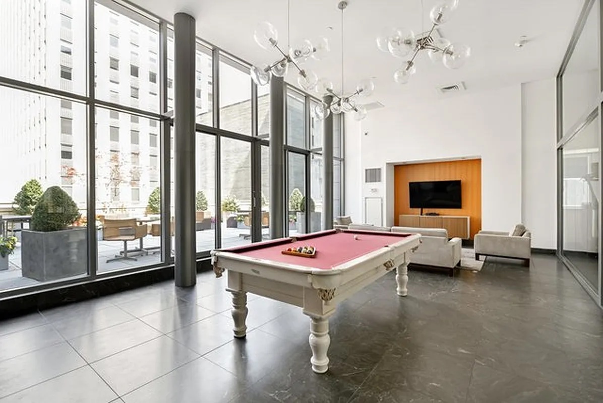 90 William Street, Unit 15F Manhattan, NY 10038 - Photo 8 of 10 a room with pool table and windows