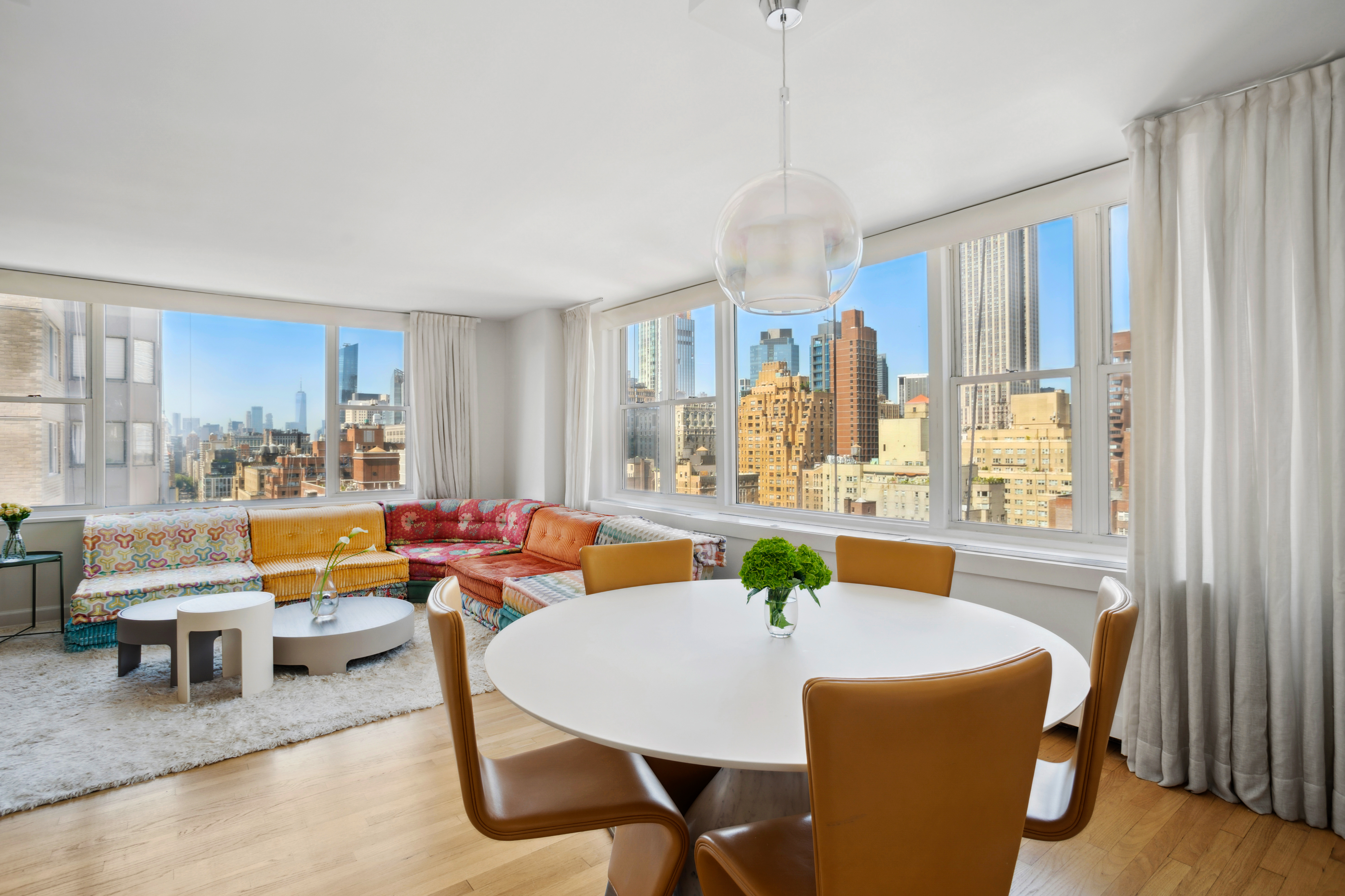 137 East 36th Street, Unit 21F Manhattan, NY 10016 - Photo 2 of 18 a dining room with furniture a chandelier and wooden floor