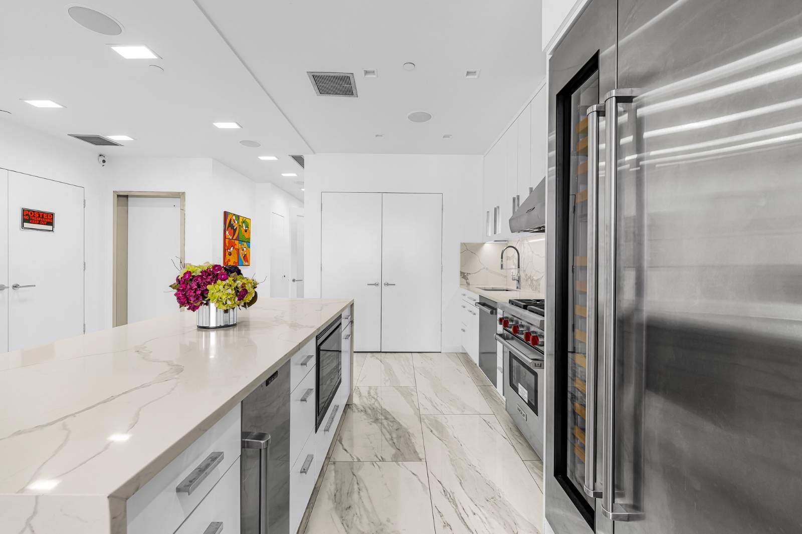 124 East 13th Street, Unit 3 Manhattan, NY 10003 - Photo 8 of 26 a hallway with a white stove top oven and a refrigerator