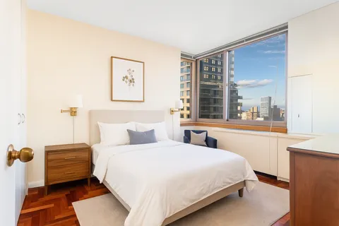 a bedroom with a bed and window