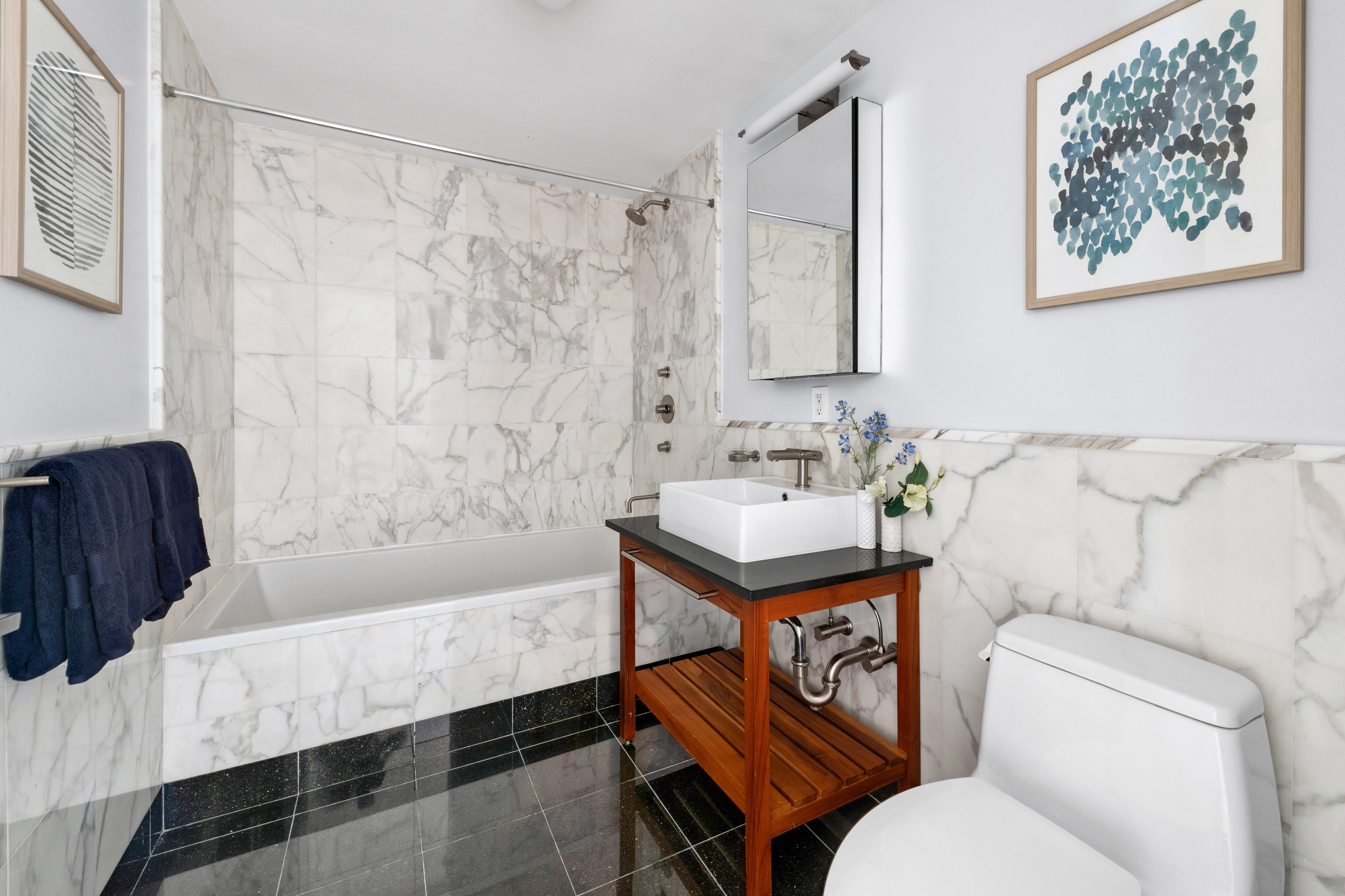 146-148 West 22nd Street, Unit PH Manhattan, NY 10011 - Photo 8 of 13 a bathroom with a sink toilet and a bathtub