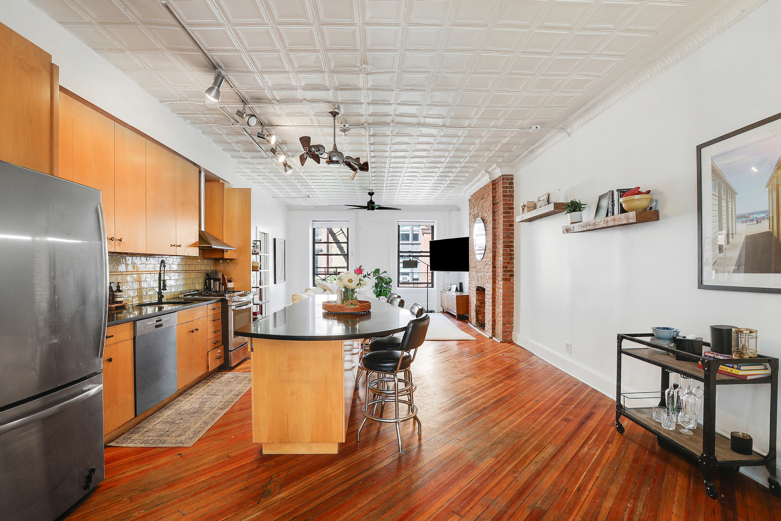 5 Great Jones Street Manhattan, NY 10012 - Photo 3 of 11 a kitchen with stainless steel appliances granite countertop a stove and refrigerator