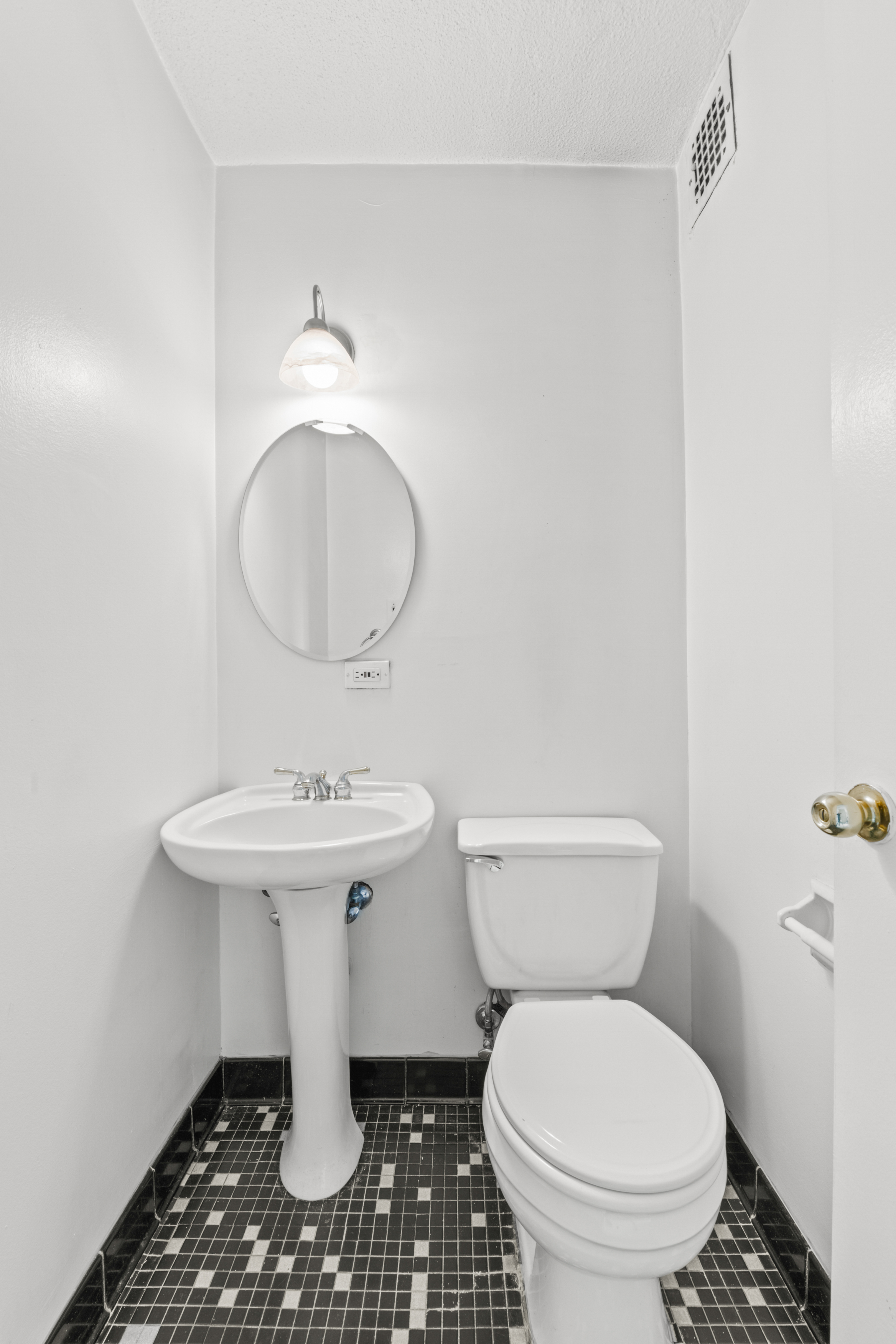 609 Columbus Avenue, Unit 14C Manhattan, NY 10024 - Photo 4 of 8 a bathroom with a sink a toilet and a mirror