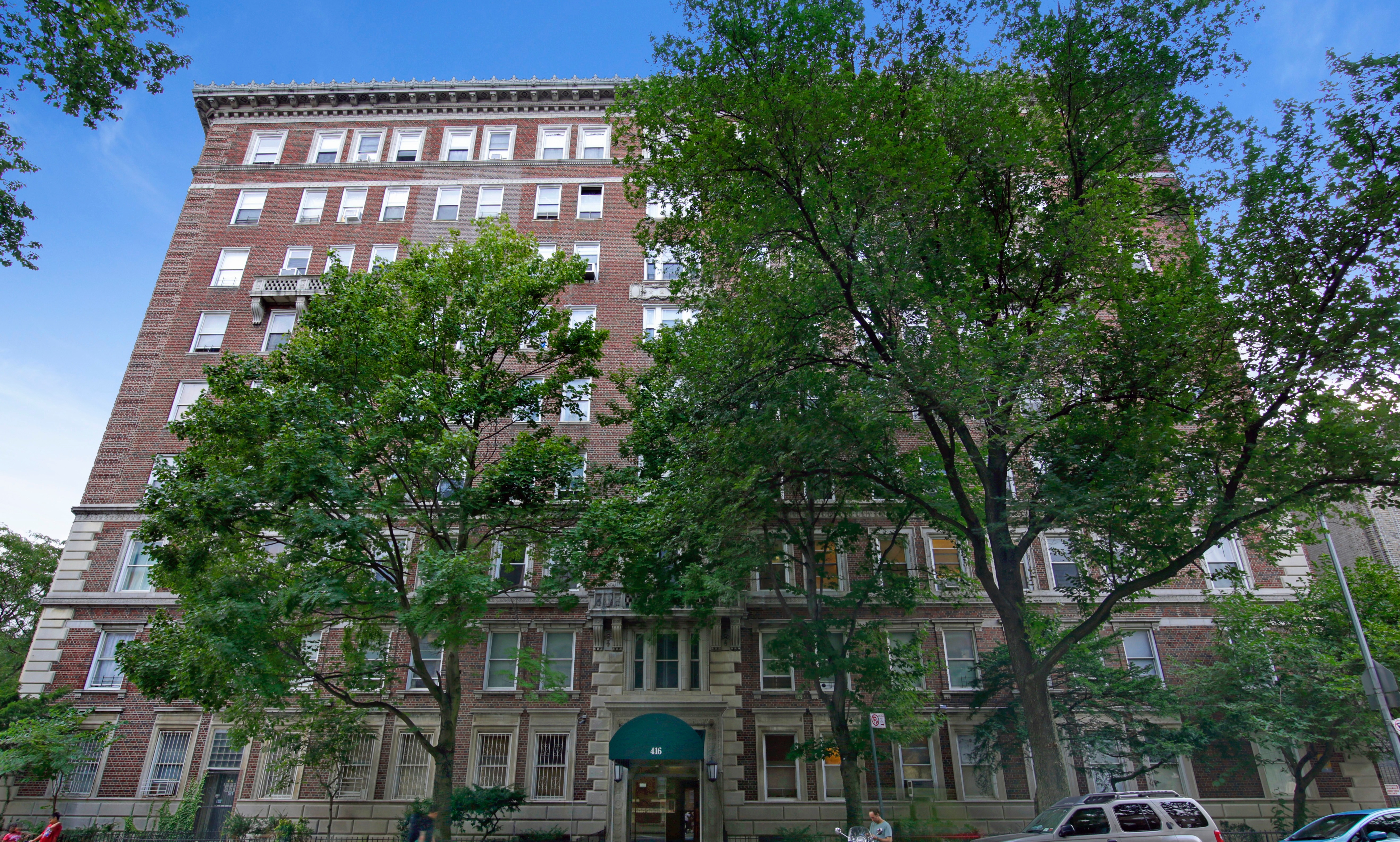 416 Ocean Avenue, Unit 48 Brooklyn, NY 11226 - Photo 12 of 14 a front view of a residential apartment building with a yard