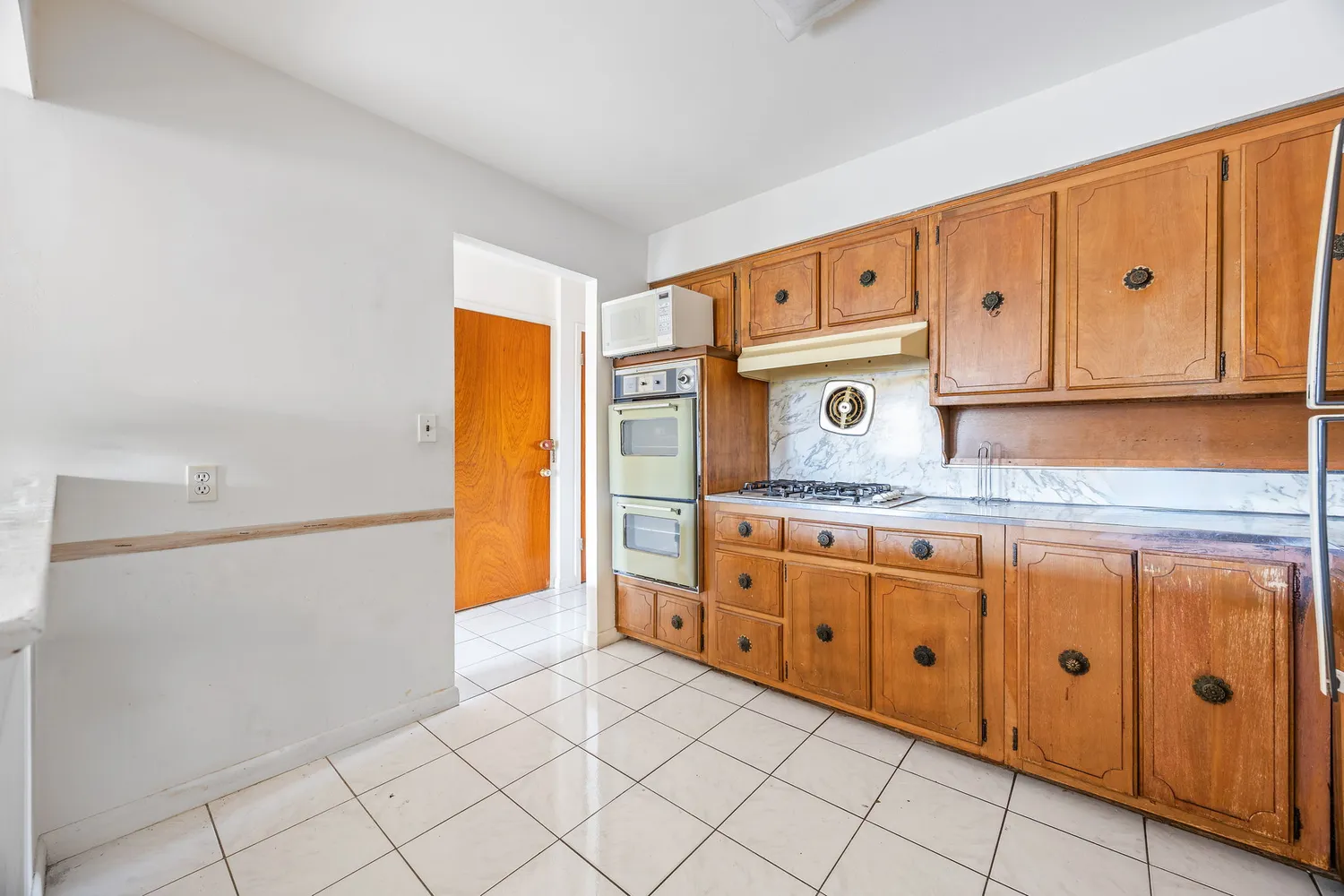 a kitchen with granite countertop white cabinets and stainless steel appliances