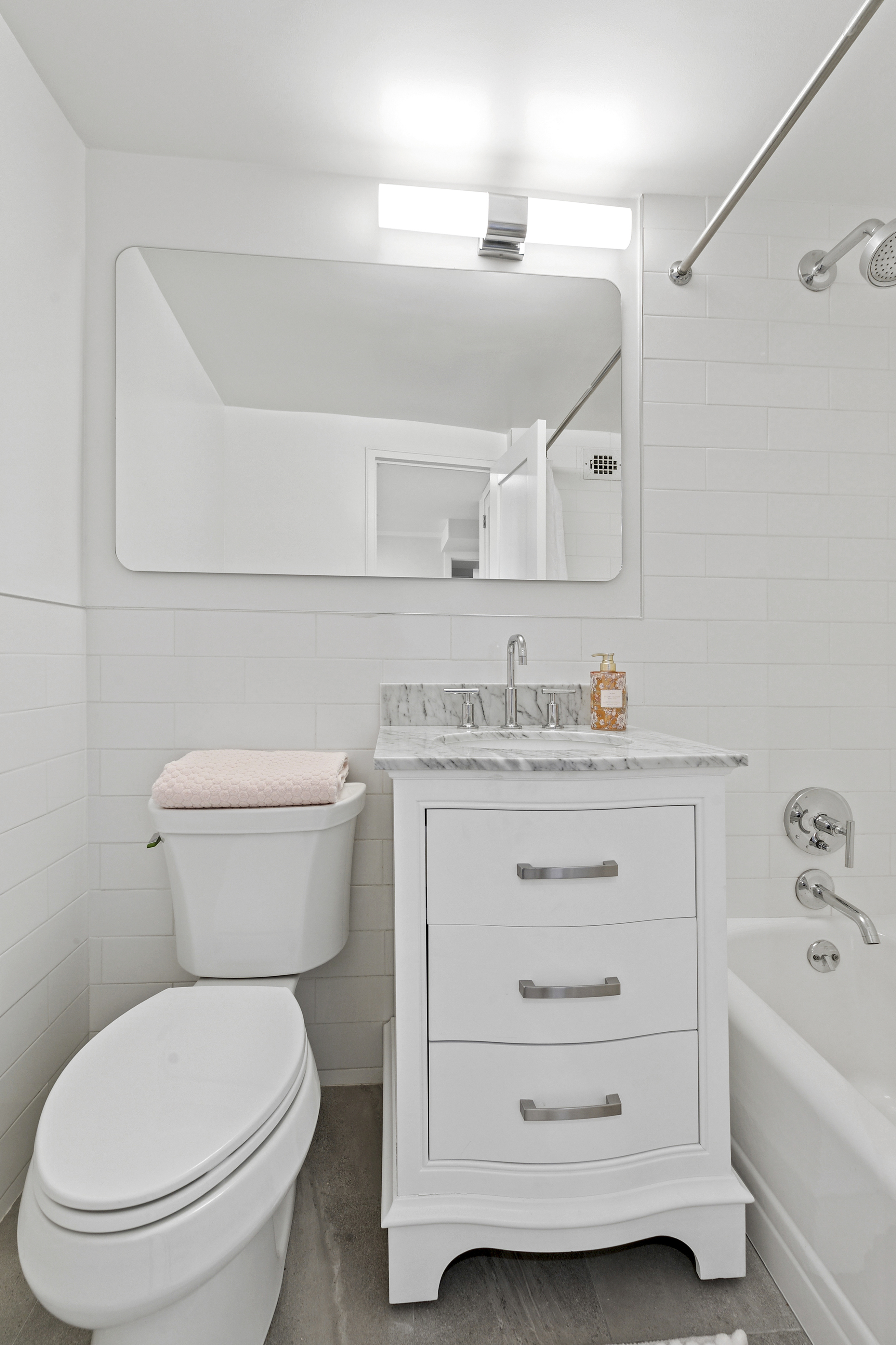 300 East 71st Street, Unit 17DEF Manhattan, NY 10021 - Photo 11 of 16 a bathroom with a granite countertop toilet sink and mirror