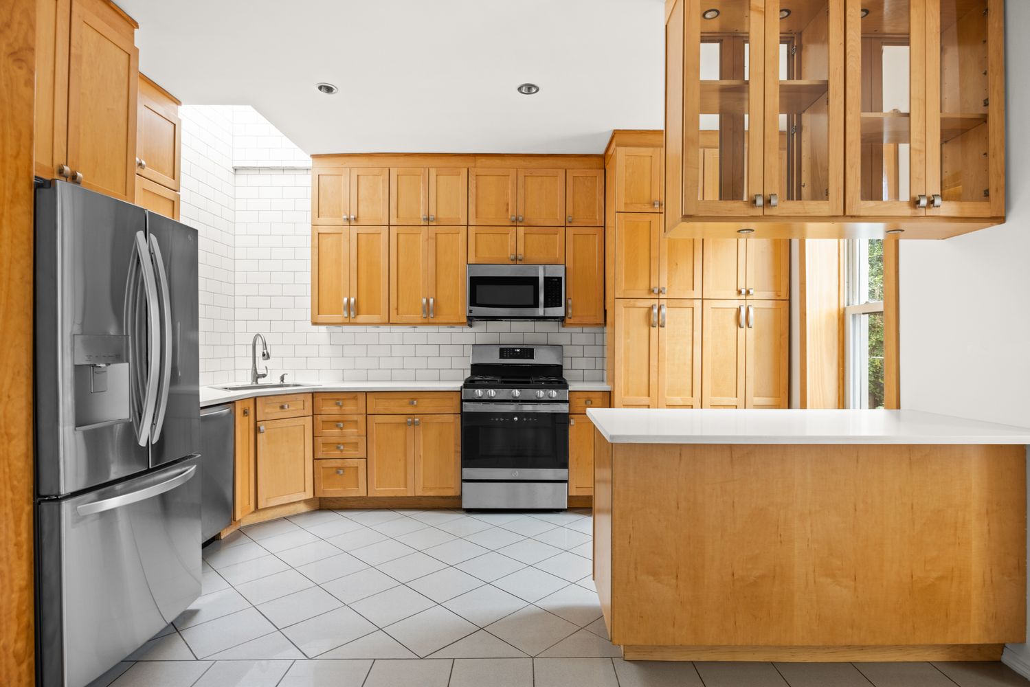 a kitchen with stainless steel appliances granite countertop a refrigerator and a stove