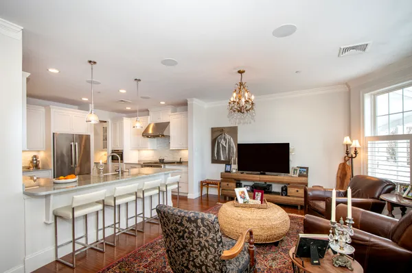 a living room with furniture and a chandelier