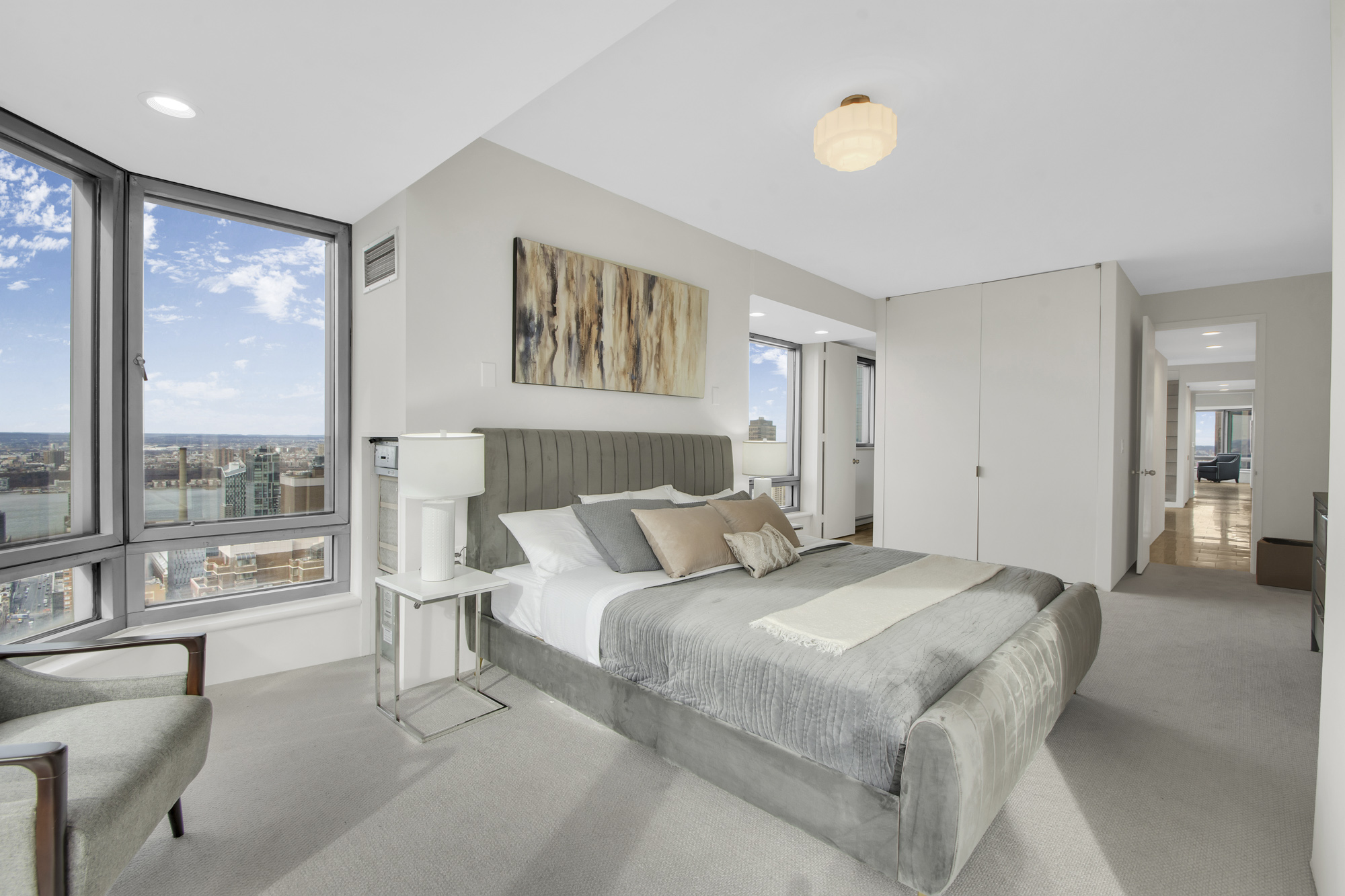 301 West 57th Street, Unit 48A Manhattan, NY 10019 - Photo 15 of 22 a bedroom with a large bed and a large window