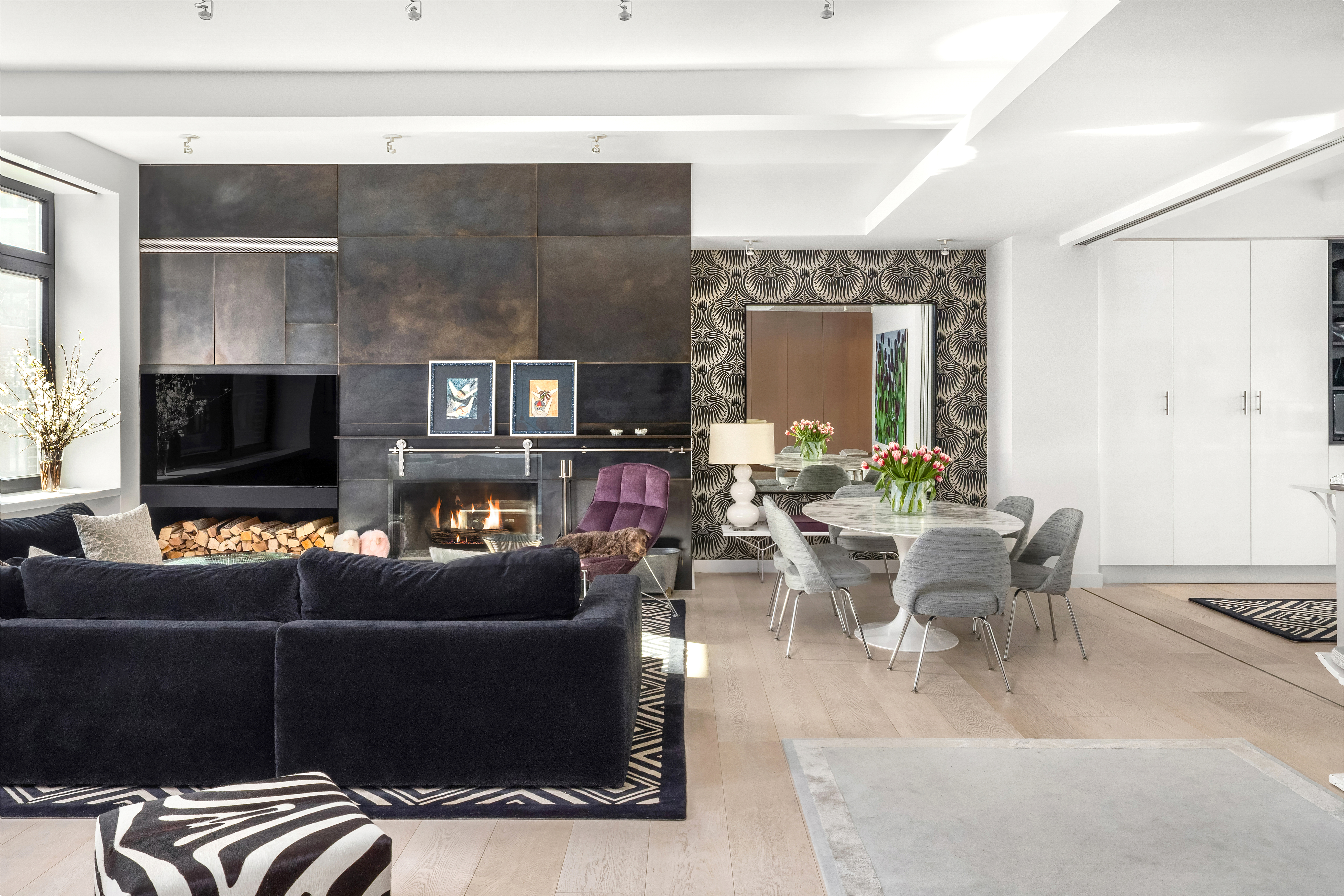 138 Reade Street, Unit 5 Manhattan, NY 10013 - Photo 3 of 23 a living room with furniture a flat screen tv and a fireplace