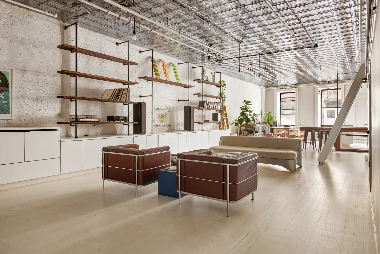 a living room with furniture a ceiling fan and a rug