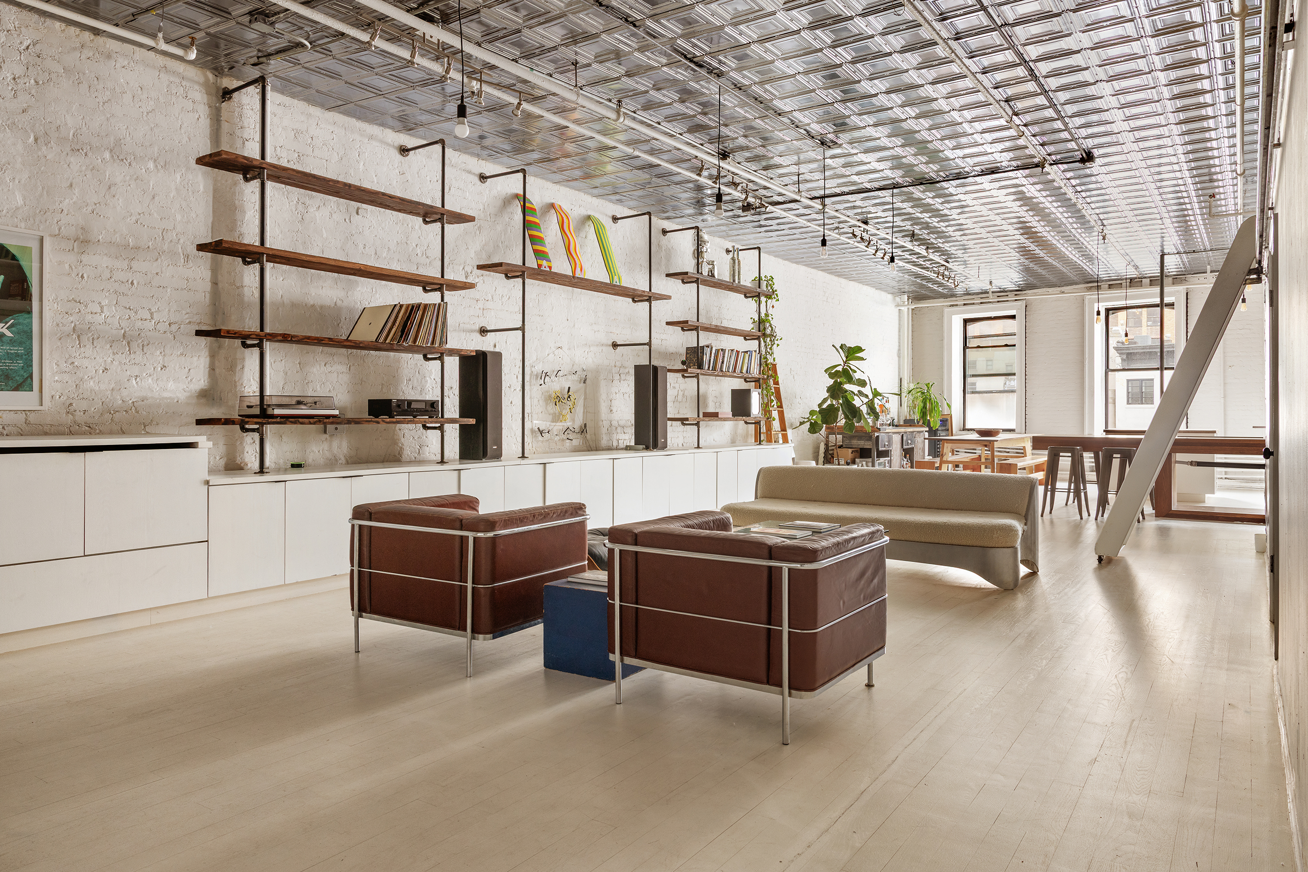a living room with furniture a ceiling fan and a rug