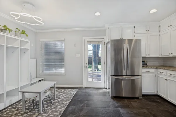 a kitchen with stainless steel appliances granite countertop a refrigerator and a stove top oven