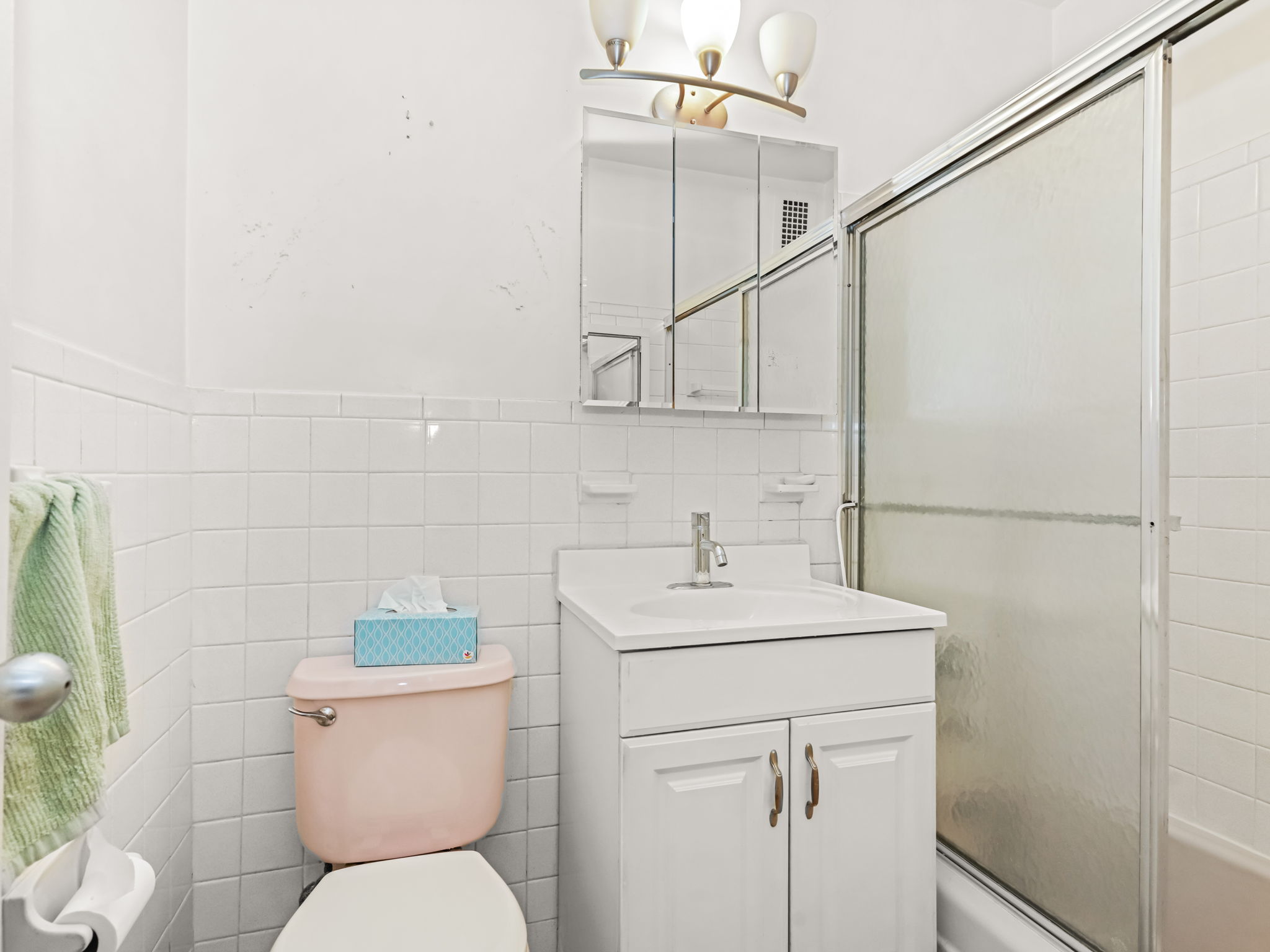 555 Kappock Street, Unit 11J Bronx, NY 10463 - Photo 17 of 24 a bathroom with a toilet sink and mirror