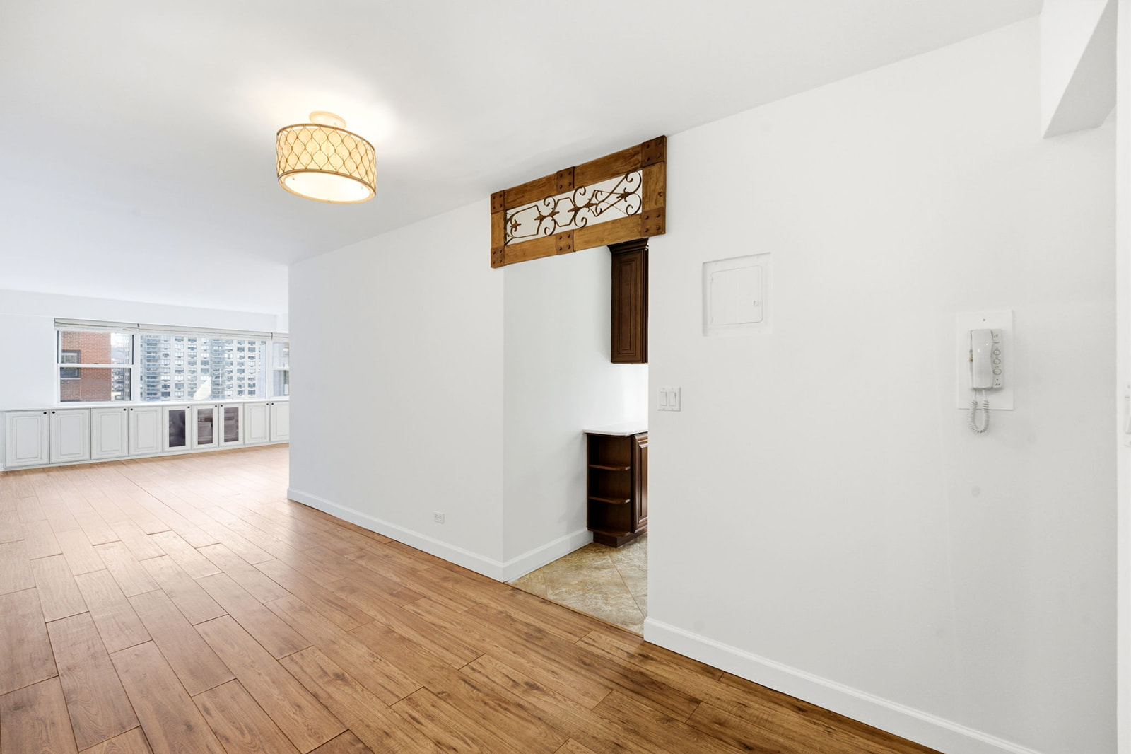 139 East 33rd Street, Unit 12DE Manhattan, NY 10016 - Photo 14 of 27 a view of an empty room with wooden floor and a window