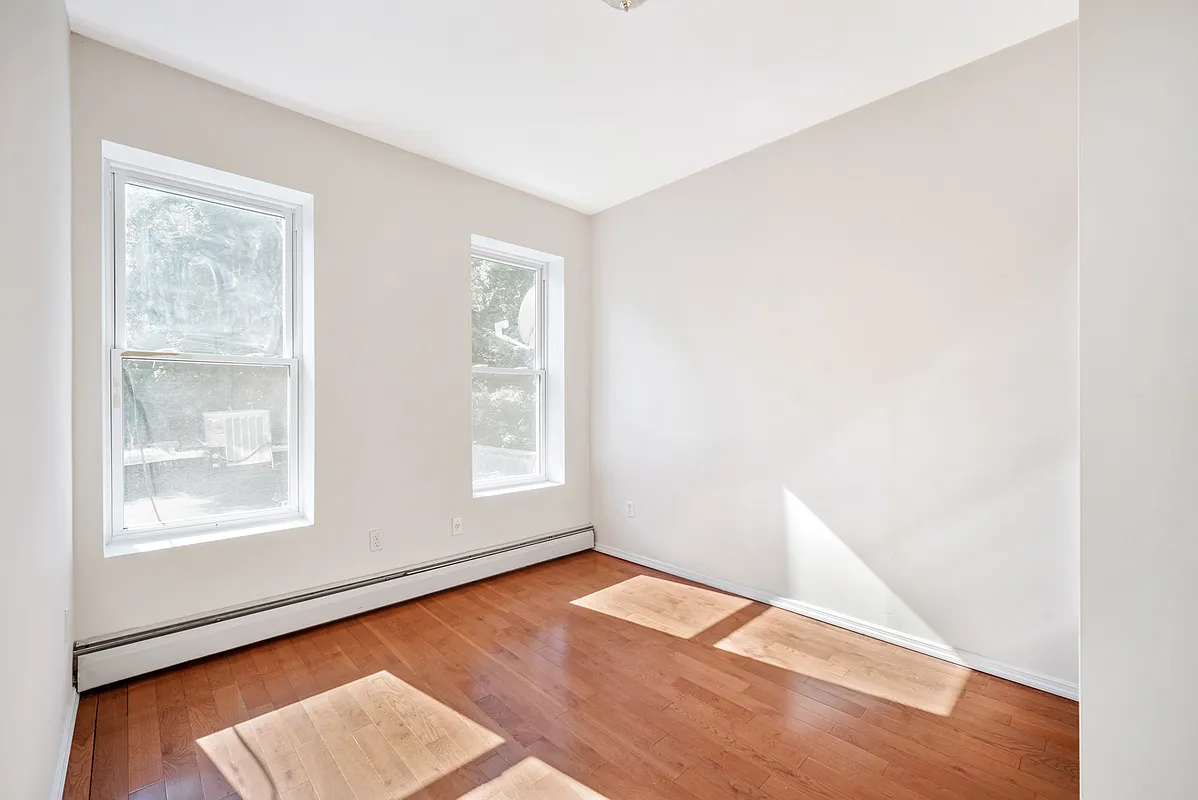 1402 Cortelyou Road, Unit 3 Brooklyn, NY 11226 - Photo 5 of 8 an empty room with wooden floor and windows