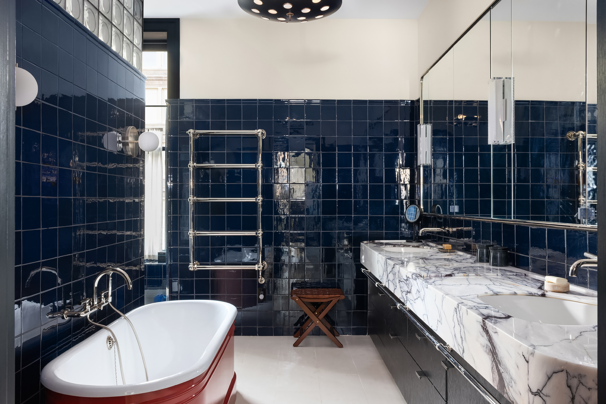 158 Mercer Street, Unit 6B Manhattan, NY 10012 - Photo 12 of 16 a bathroom with a granite countertop sink a mirror and shower