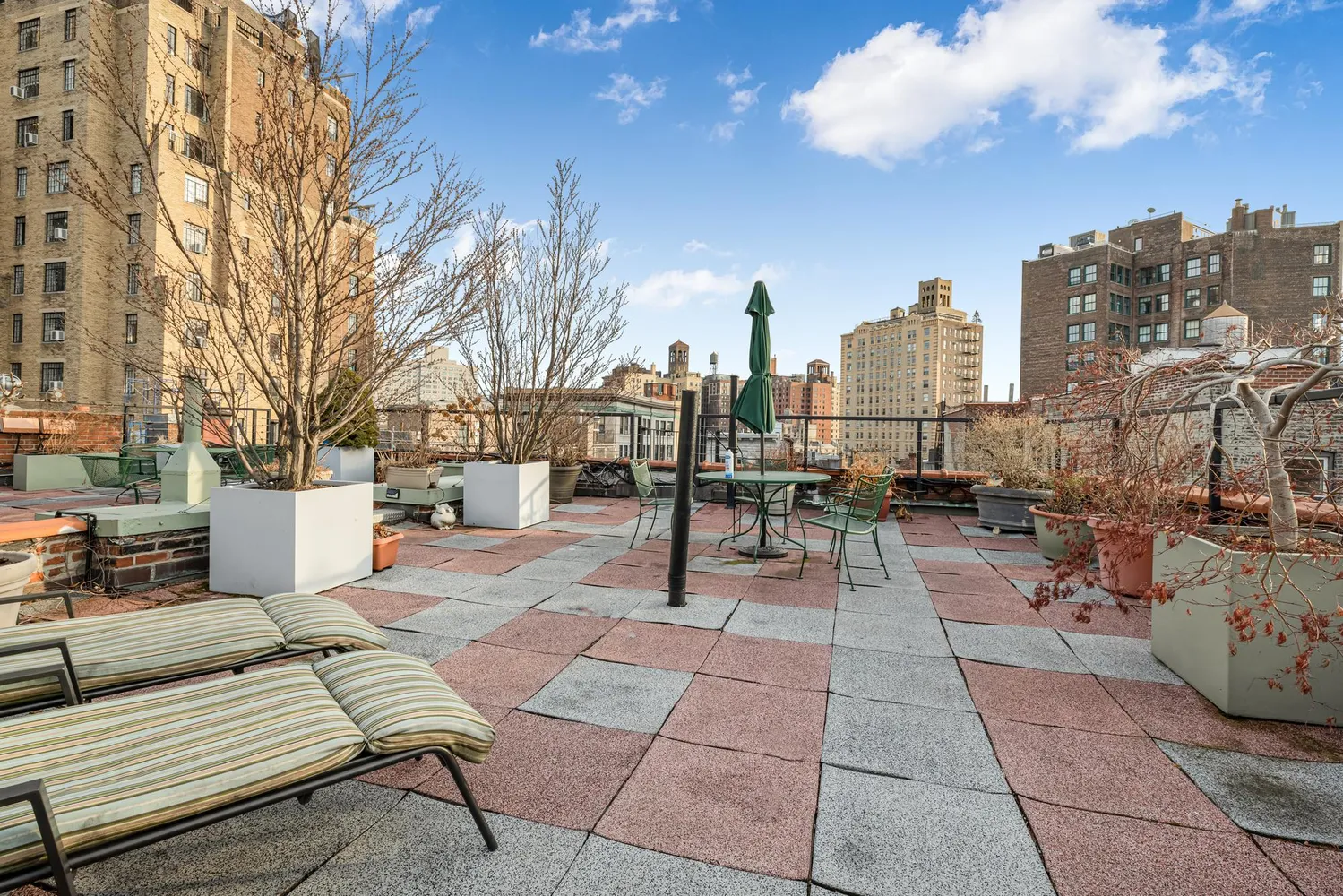 a view of a patio with couches and fire pit