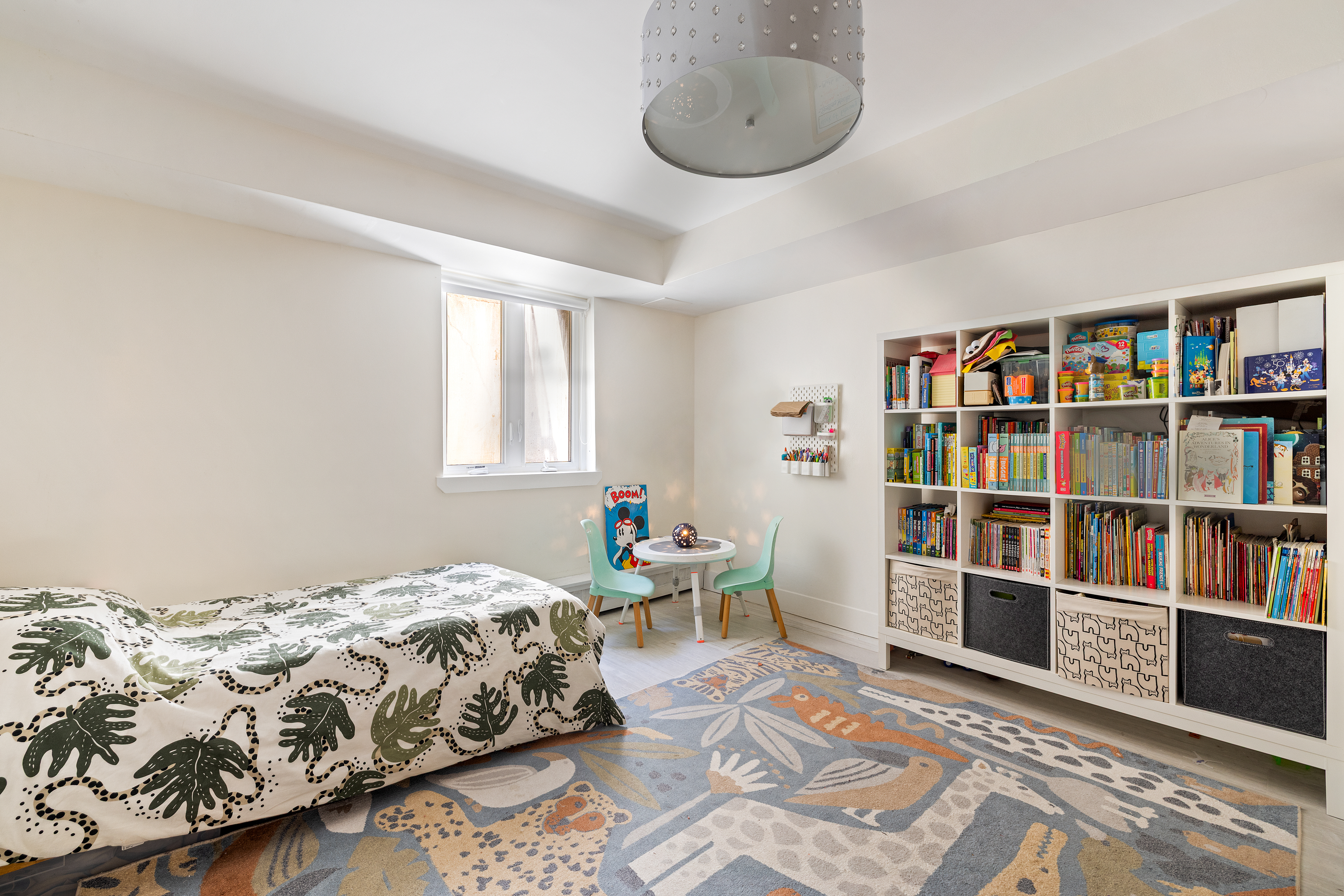 1115-1139 Prospect Avenue, Unit 1B Brooklyn, NY 11218 - Photo 8 of 9 a bedroom with a bed and a book shelf