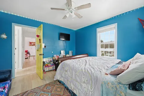 a bedroom with bed and a window