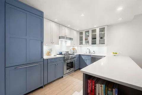 a kitchen with a sink a stove and cabinets
