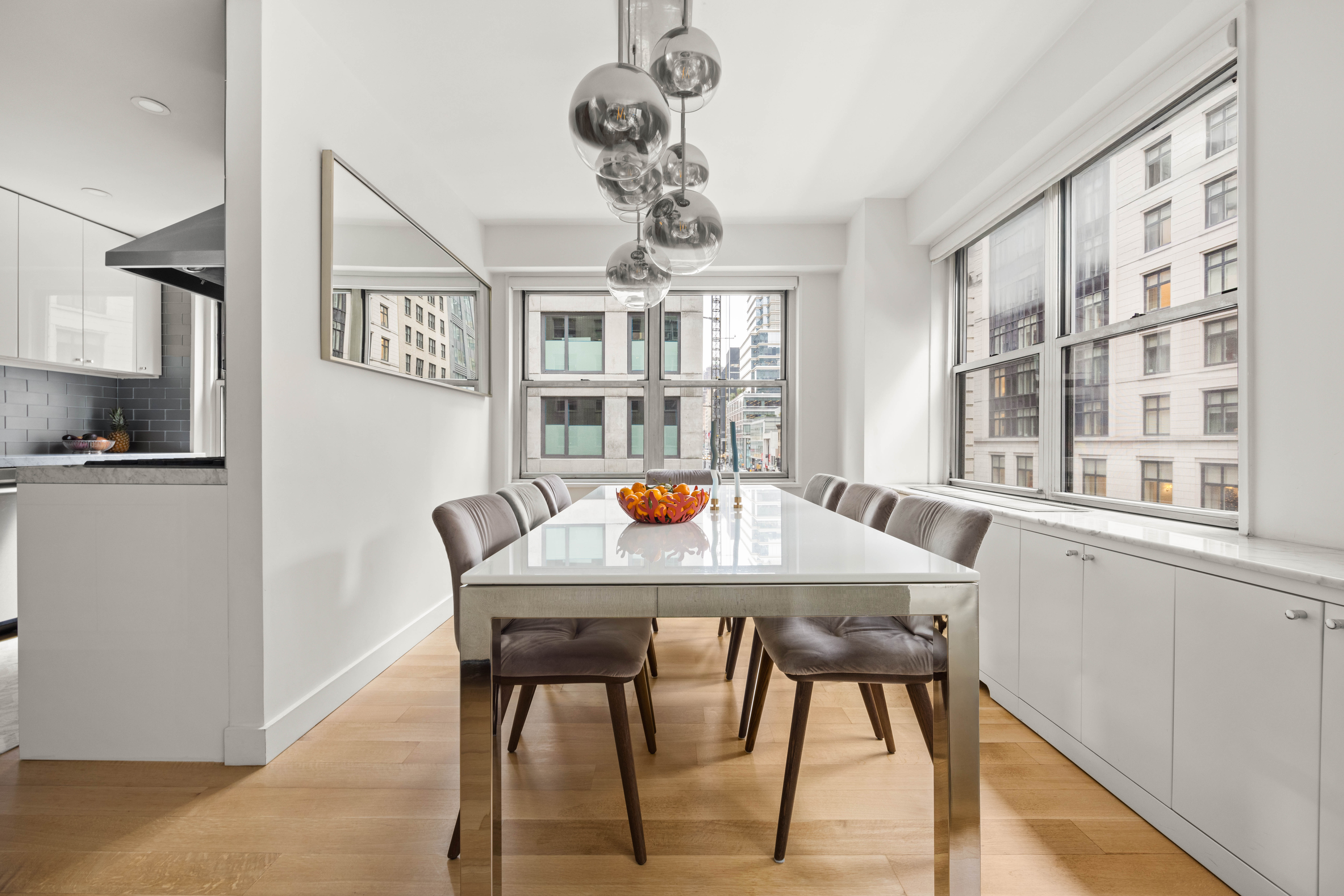 136 East 56th Street, Unit 4EF Manhattan, NY 10022 - Photo 4 of 10 a dining room with a table chairs and entryway