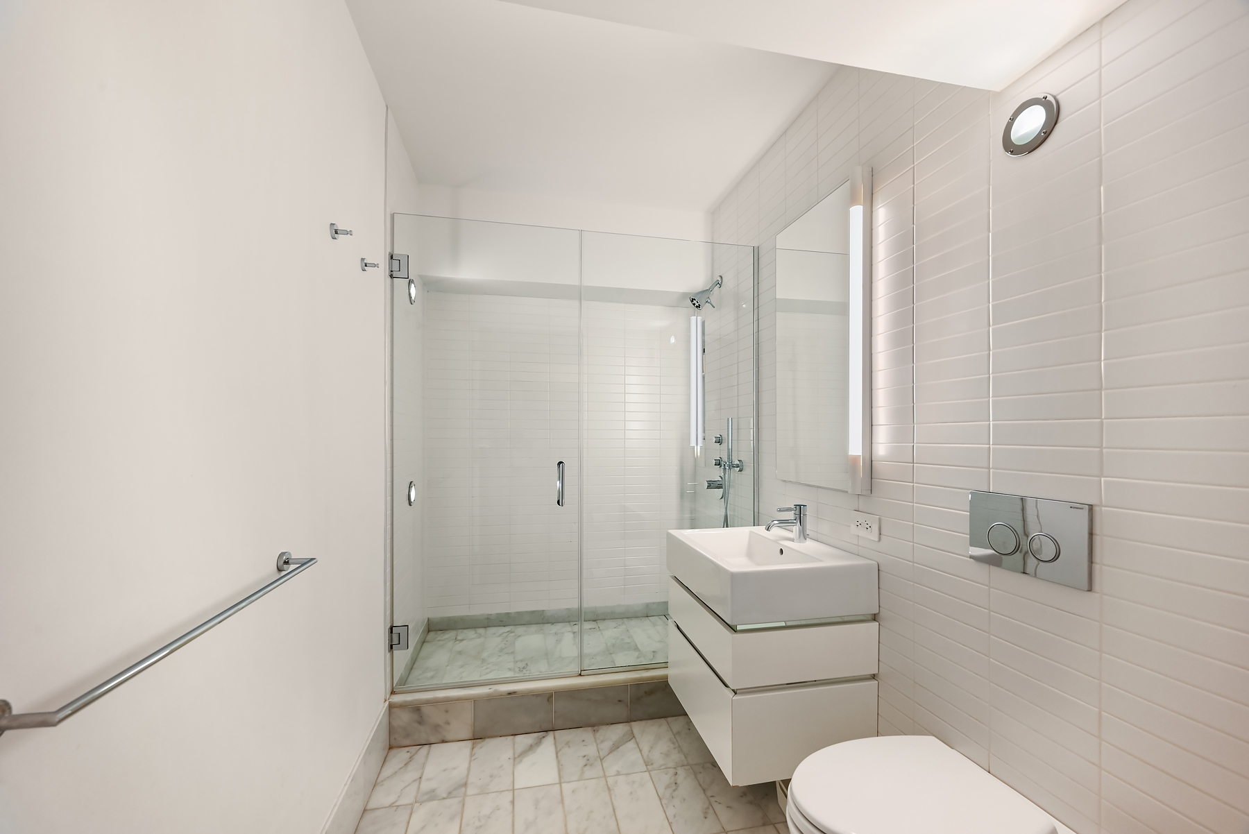 421 Hudson Street, Unit 318 Manhattan, NY 10014 - Photo 10 of 12 a bathroom with a sink a toilet and shower