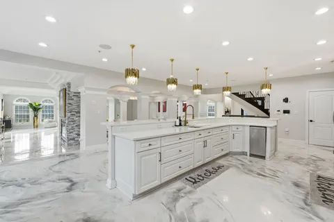 a large bathroom with a large mirror vanity and sink