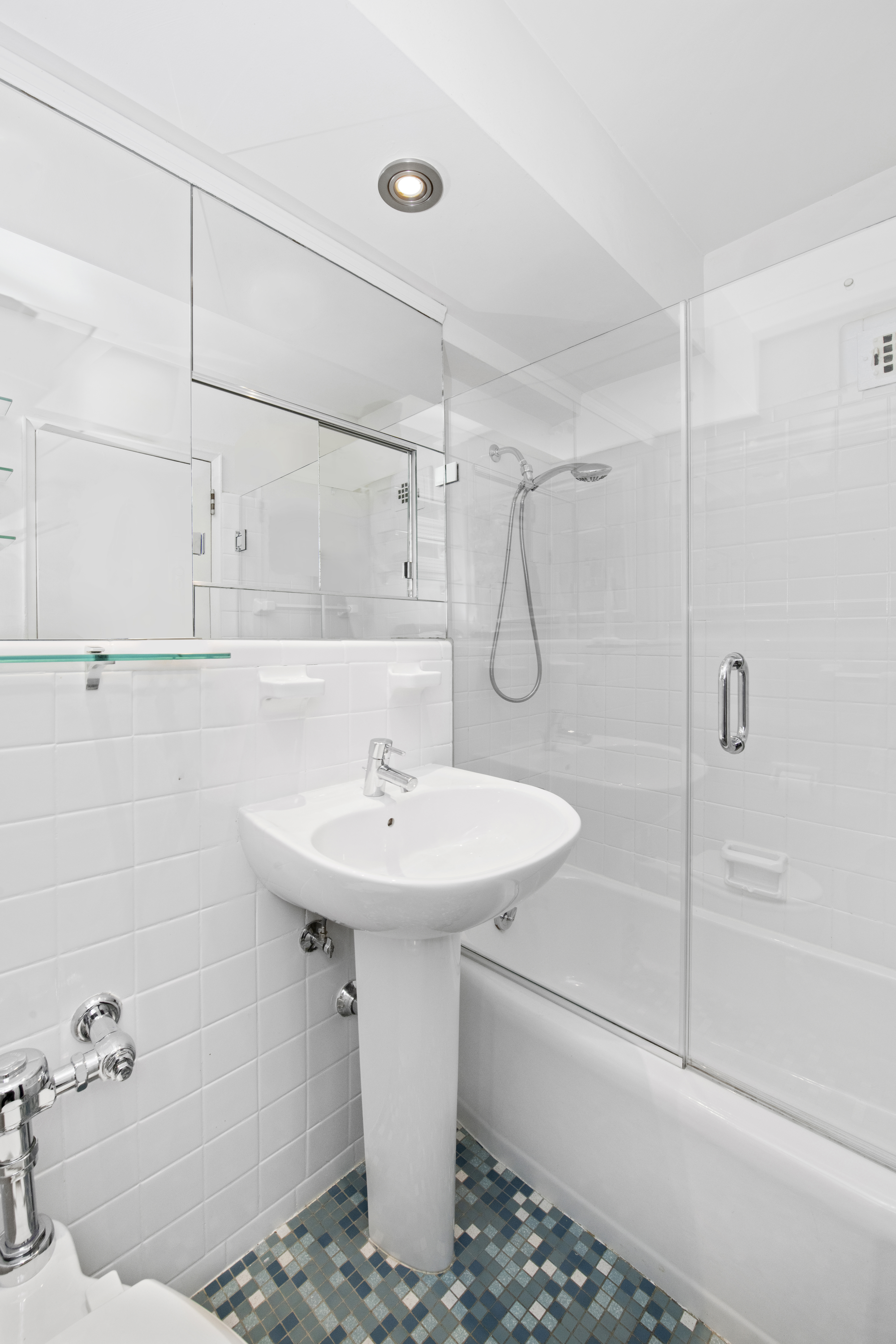 69 West 9th Street, Unit 9H Manhattan, NY 10011 - Photo 4 of 6 a bathroom with a sink a toilet and shower