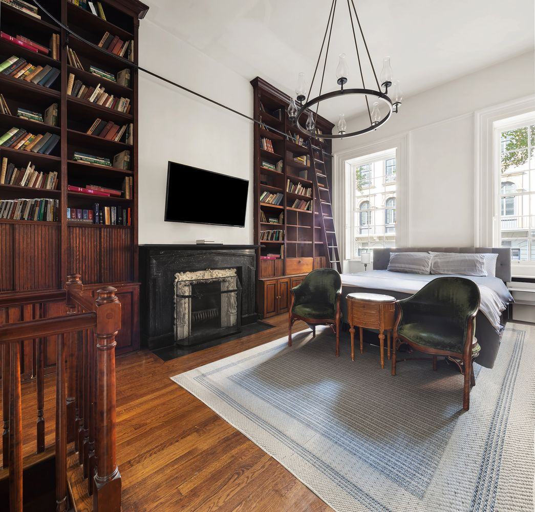 20 West 9th Street, Unit DUPLEX Manhattan, NY 10011 - Photo 5 of 10 a living room with furniture a fireplace and a flat screen tv
