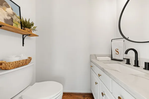 a bathroom with a toilet sink and mirror