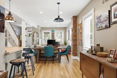 a view of a dining room with furniture and wooden floor