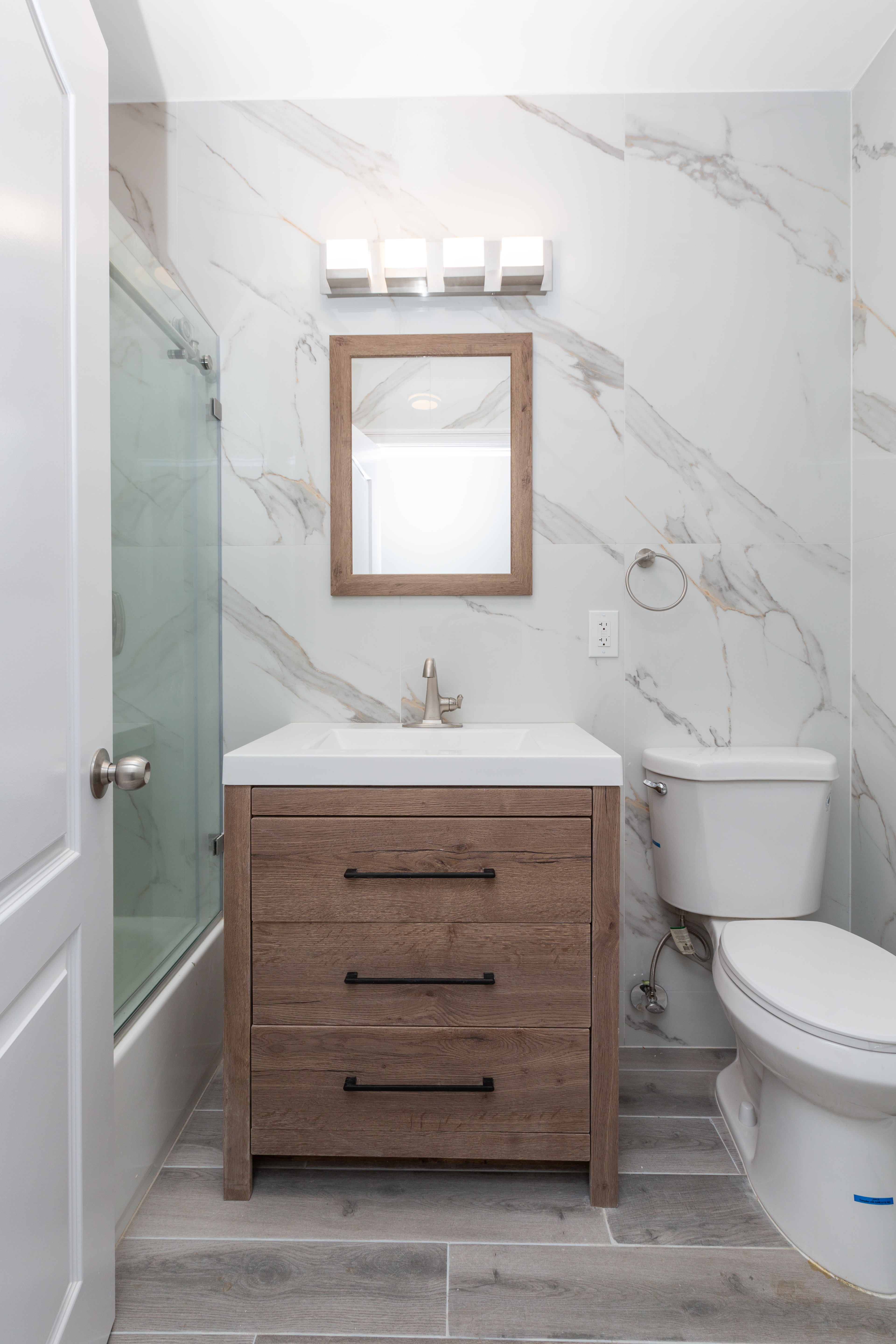 143-10 Shore Avenue Queens, NY 11435 - Photo 16 of 30 a bathroom with a granite countertop toilet sink and mirror