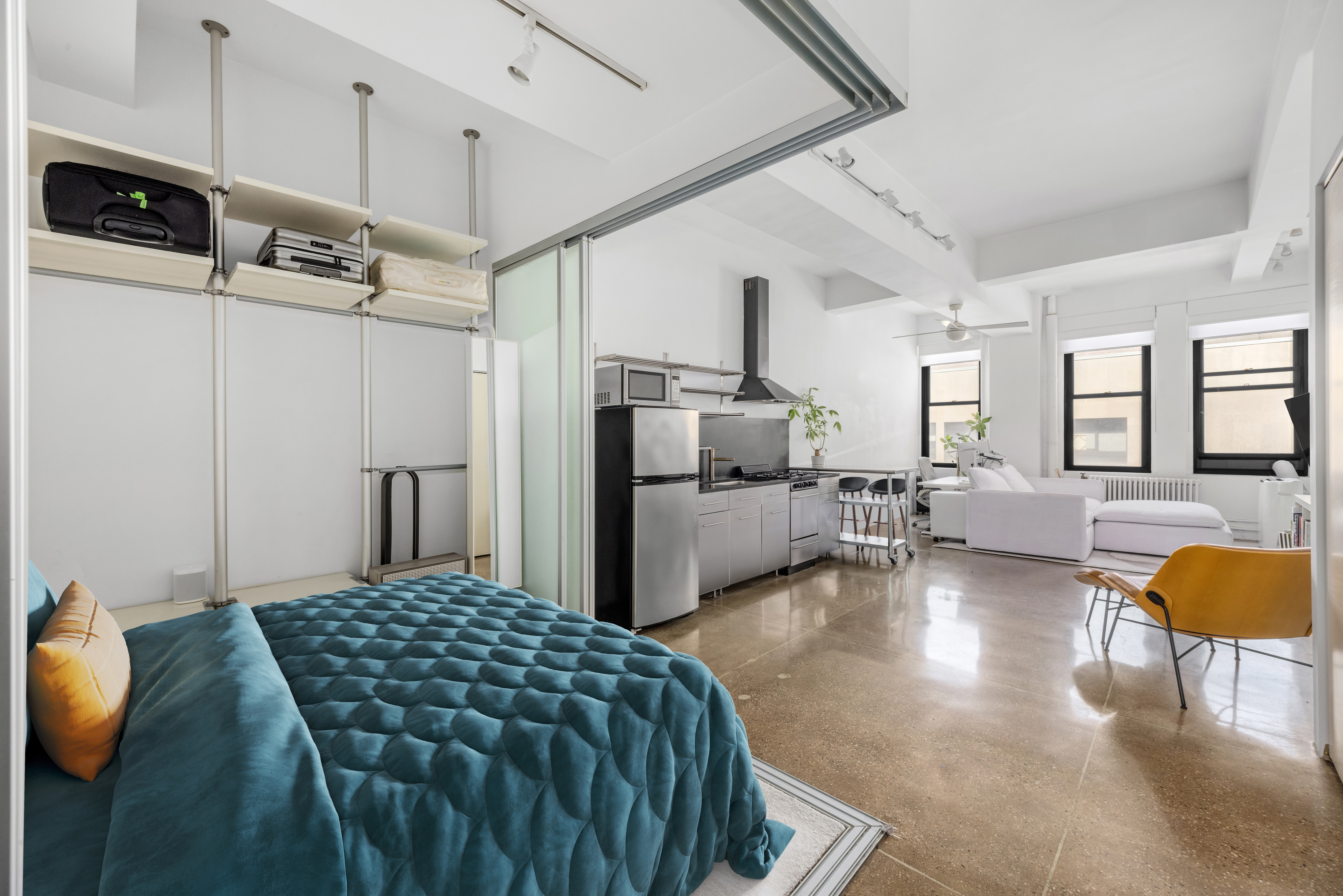 a kitchen with stainless steel appliances kitchen island granite countertop a refrigerator and microwave