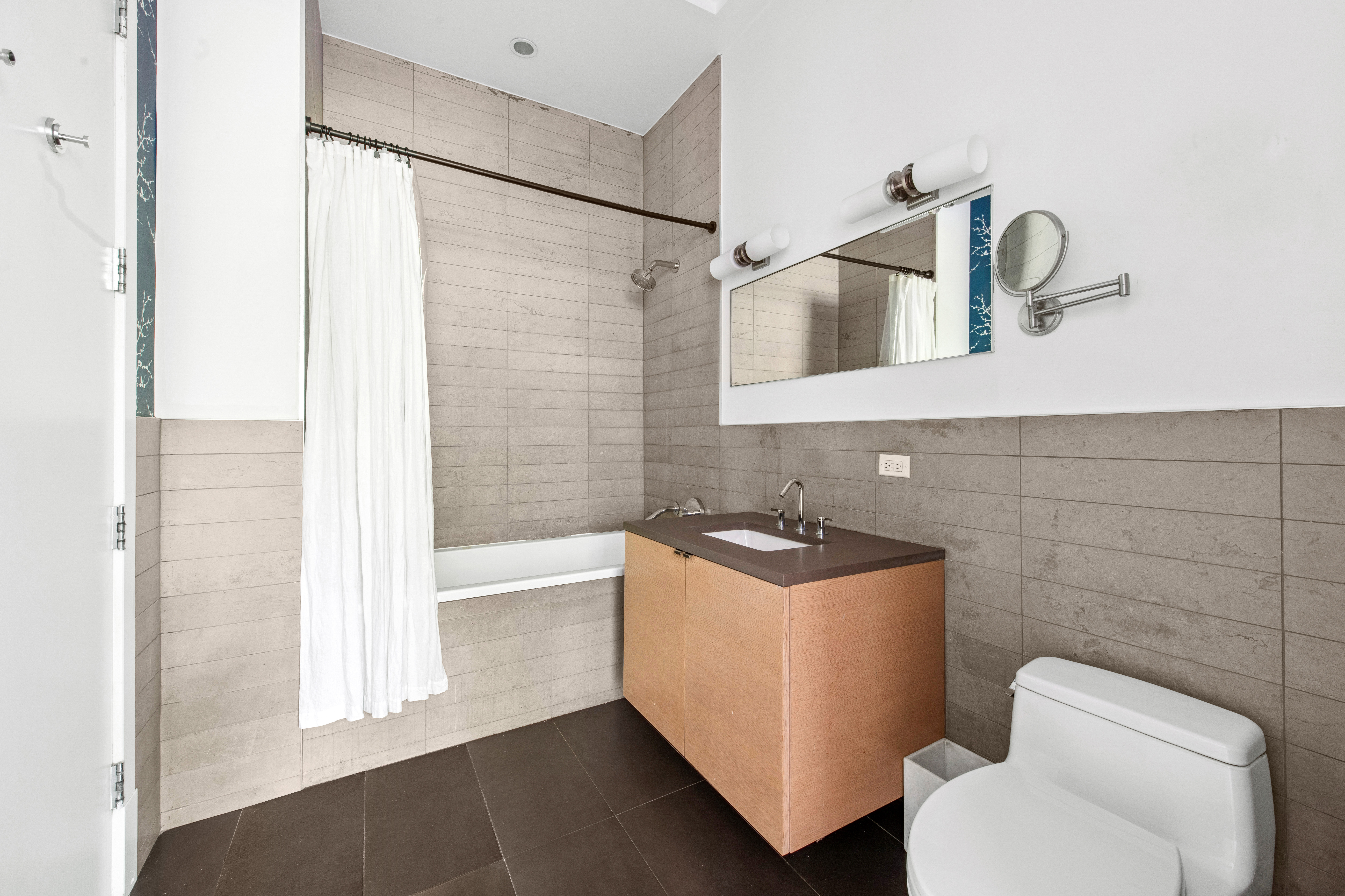 50 Bayard Street, Unit 1B Brooklyn, NY 11211 - Photo 4 of 13 a bathroom with a sink a toilet and shower