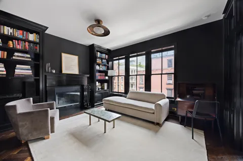 a living room with furniture and a floor to ceiling window