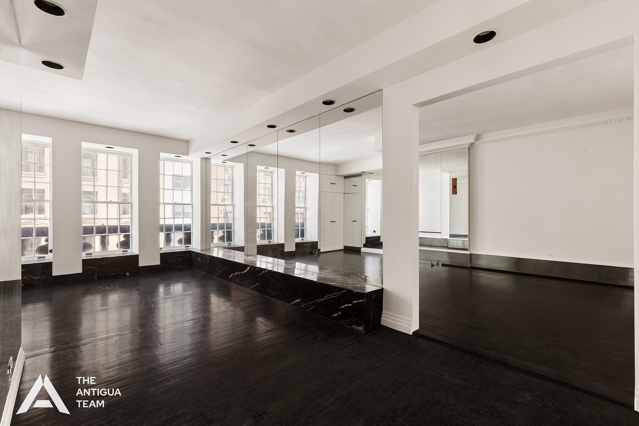 45 East 66th Street, Unit 4W Manhattan, NY 10065 - Photo 3 of 27 a living room with hard wood floors and a window