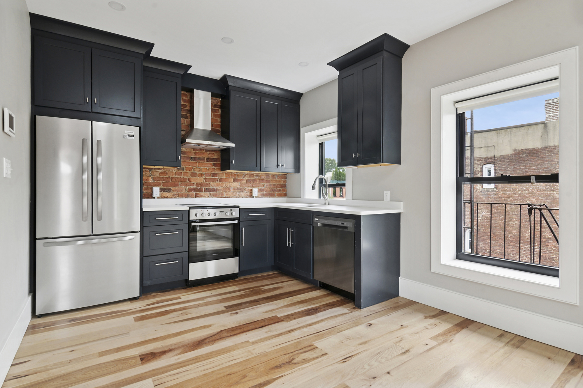 264 Stuyvesant Avenue, Unit 4 Brooklyn, NY 11221 - Photo 2 of 8 a kitchen with stainless steel appliances granite countertop a refrigerator and a stove top oven